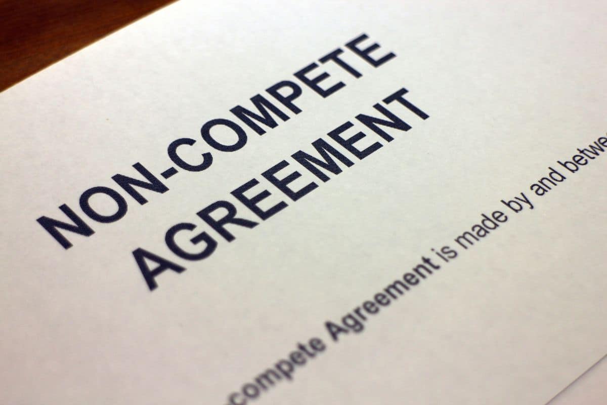 Non-compete agreement document with bold text on a white background. Partial sentence visible at the bottom. Professional and formal setting.
